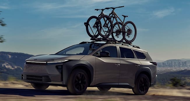 2026 Toyota bZ Woodland driving, front, with bikes