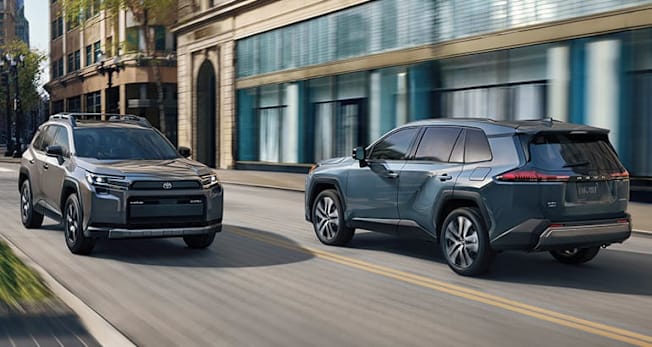 2026 Toyota RAV4 Woodland and Limited passing one another on a city street