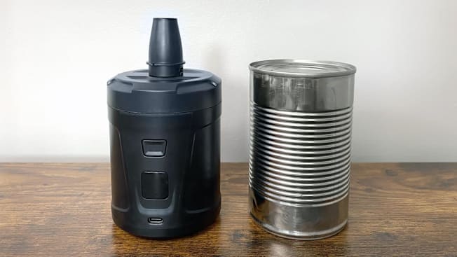 VacPack vacuum pump next to can of food on wooden surface with white wall