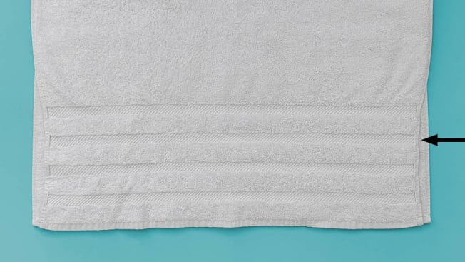 Detail photo showing band details on a bath towel that shrunk when washed and dried more than other parts of the towel.