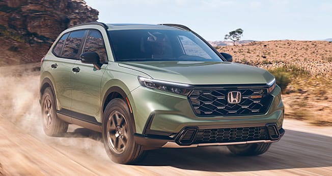 2026 Honda CR-V TrailSport Hybrid driving on a dirt road