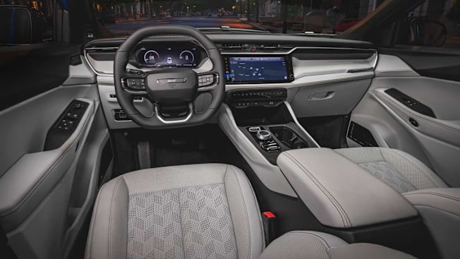 Interior of the 2026 Jeep Cherokee showing passenger and driver seats and dashboard.