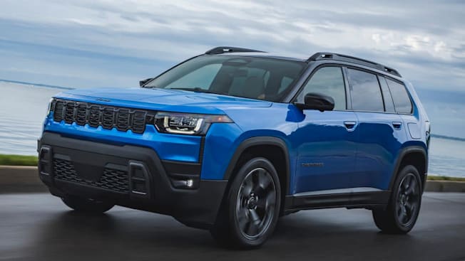 2026 Jeep Cherokee driving on a road.