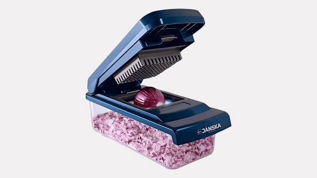 Vegetable chopper with a red onion.