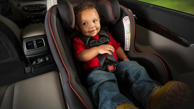 A 1 year old in rear-facing convertible car seat.