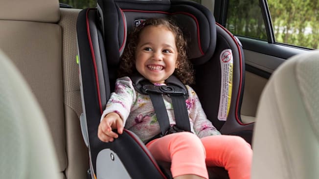 A 2 year old in forward-facing all-in-one or convertible car seat.