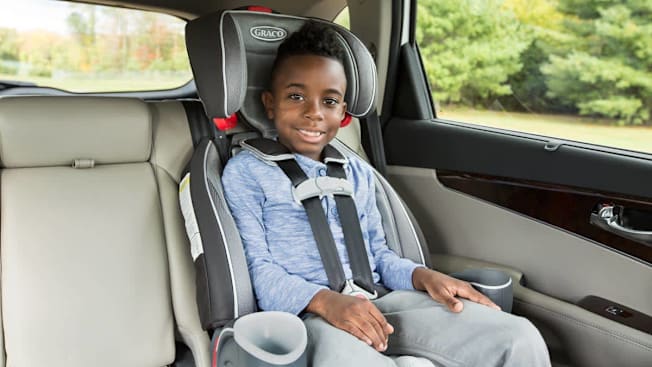A 6-7 year old in forward-facing harnessed booster seat.