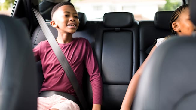 A 10-11 year old child buckled into a car in a seat belt without a booster.