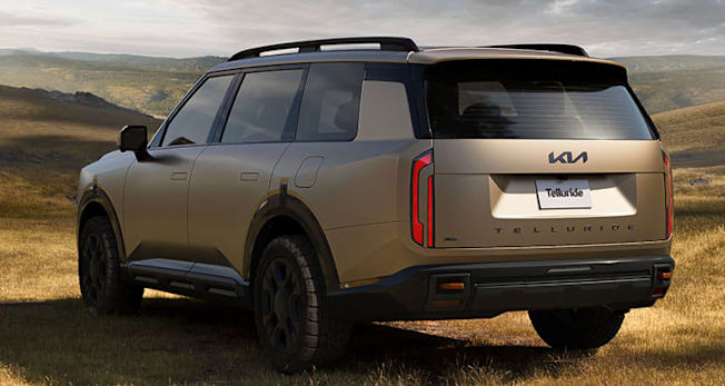 Rear view of a 2027 Kia Telluride X-Pro parked on a sunny field