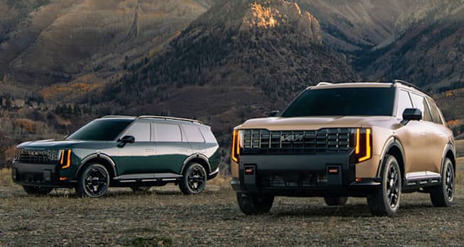 2027 Telluride HEV X-Line and 2027 Telluride X-Pro parked by a mountain
