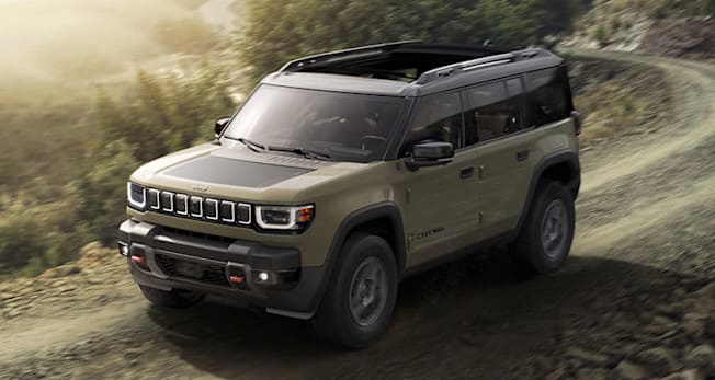 2026 Jeep Recon Moab driving down a dirt road.