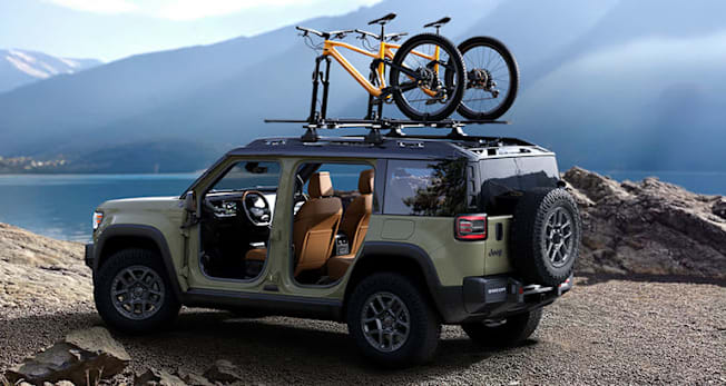 2026 Jeep Recon Electric SUV with doors off and bikes on the roof rack