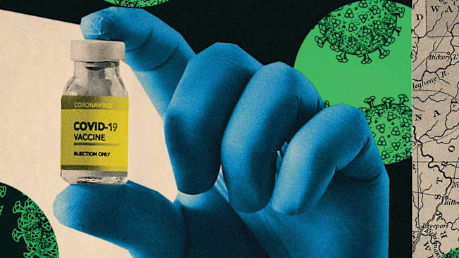 A hand holding a vile of Covid-19 Vaccine