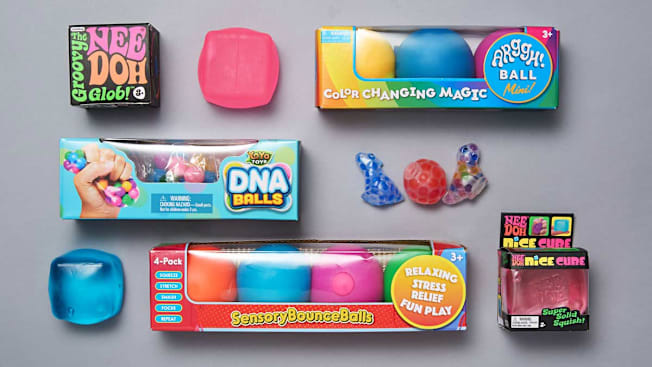 Shown: Nee-Doh Groovy Glob, ZaxiDeel Squishy Fidget Cube, Color Changing Magic Arggh Ball Minis, Yoya Toys DNA Balls, Visashine Mochi Squishy Toys, Everyday Whimtastic Handmade Ice Cube Stressball, Playbees Sensory Bounce Balls, Nee-Doh Nice Cube
