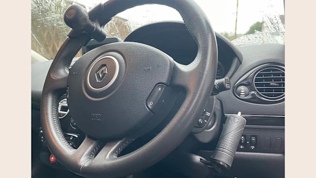 A car steeling wheel showing control handles including a steering ball.