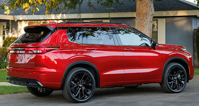 2026 Nissan Rogue Plug-in Hybrid Platinum rear in front of a house