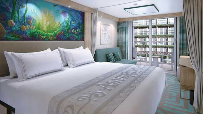 Disney Adventure Deluxe Garden View Stateroom with Verandah, featuring a queen bed and a sleeper sofa.