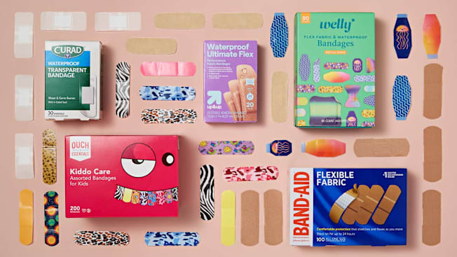 grid of Curad, Ouch Essentials, Up&Up, Band-Aid, and Welly bandage boxes and bandages