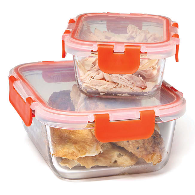 Glass storage containers holding leftover chicken.