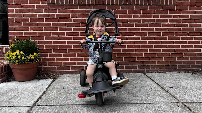 Little boy sitting in the Radio Flyer toddler trike