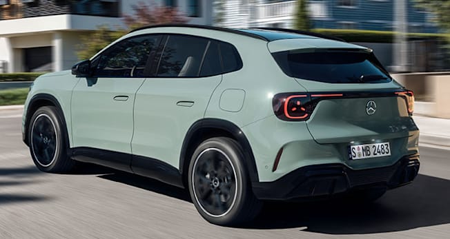 2028 Mercedes-Benz GLA driving through a neighborhood, rear