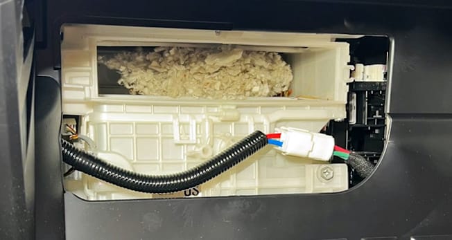 Cain air filter box filled with bedding from a mouse