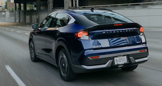 2027 Mitsubishi Eclipse Sportback rear, driving through city