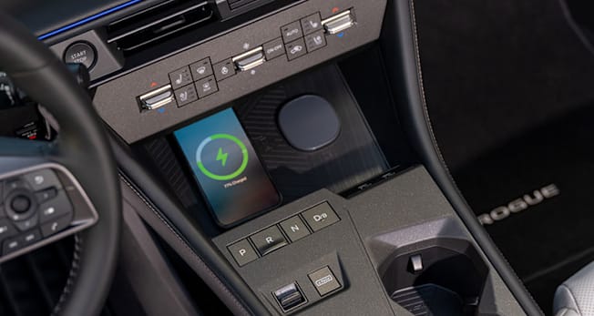 2027 Nissan Rogue Hybrid Platinum climate controls and phone charger