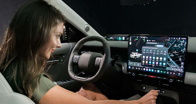 Driver in 2027 Hyundai Tucson using the  infotainment system and controls