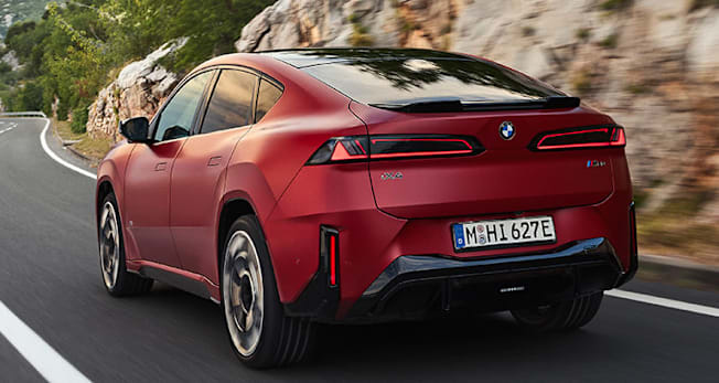 2027 BMW iX4 M60 driving, rear