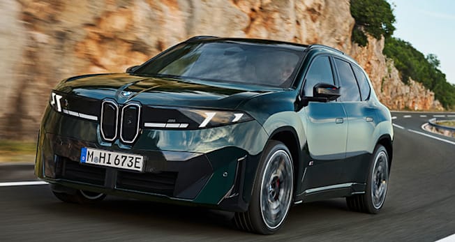 2027 BMW iX3 M60 xDrive front, driving on a twisty mountain road