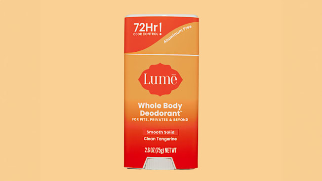 Lumē Clean Tangerine Whole Body Deodorant on light orange background