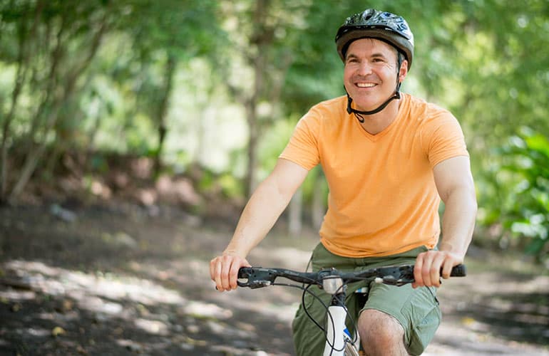 A man riding a bicycle. 