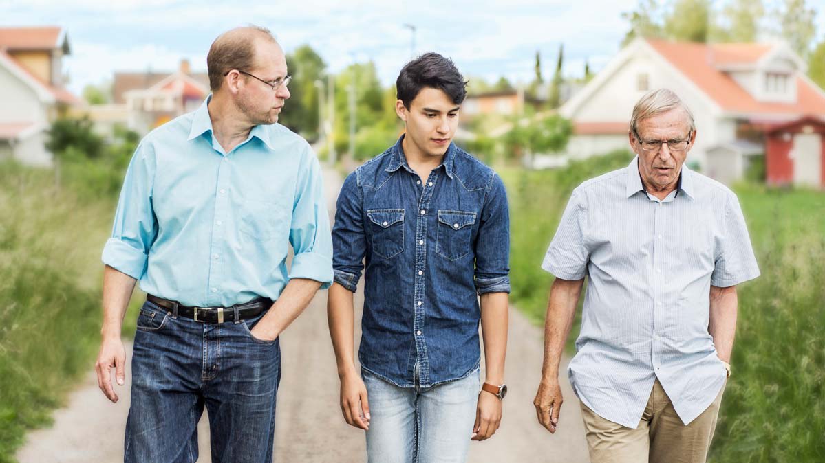 Three generations of men walking outside