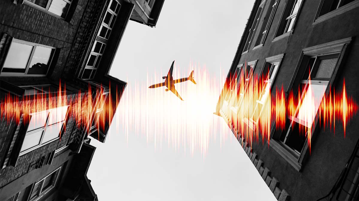 An illustration of a noisy airplane flying over a busy city.