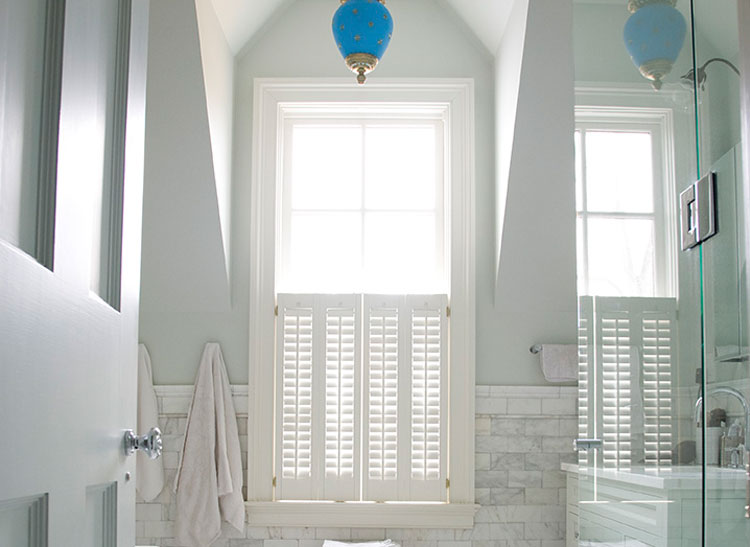 A white bathroom with blue fixtures.