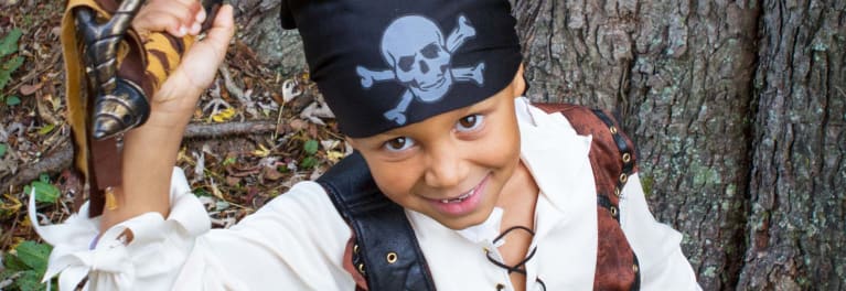 A young boy in a pirate costume.