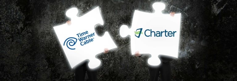 Puzzle pieces fitting together represent the Charter-Time Warner Cable merger.