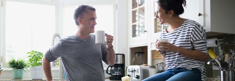 A man and a woman having a cup of coffee.
