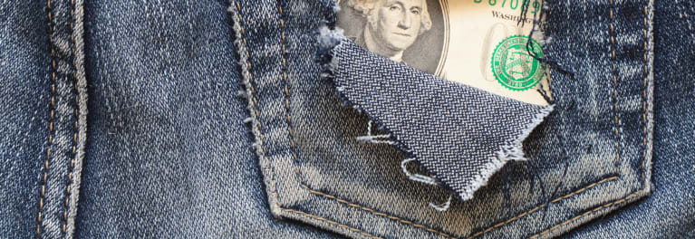 A dollar showing through the back pocket of a pair of old jeans.