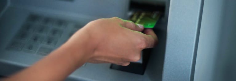 Thieves Get Craftier With Skimmers And Shimmers Consumer Reports - someone using an atm